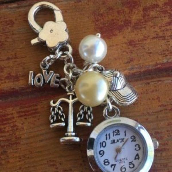 This special order was originally scooped up at Everybody Loves Flowers in Tempe. We personalized it with the scales of justice for the bride and a baseball charm for the groom.